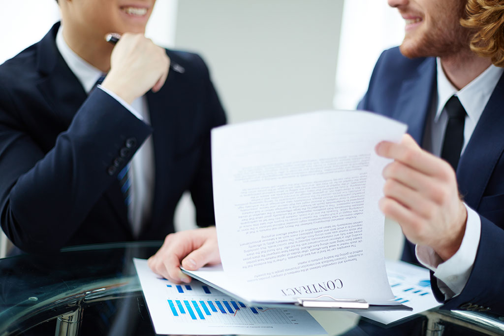 Двое мужчин читают договор